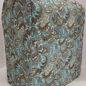 May include: A teal and brown paisley patterned kitchen appliance cover. The cover is made of fabric and has a fitted design.