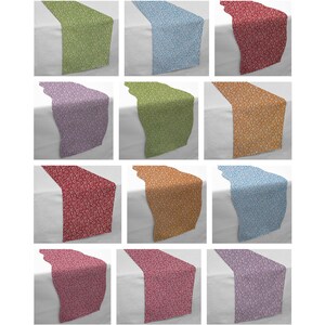May include: A set of 12 table runners in various colors and patterns. The runners are made of a soft, woven fabric and feature a floral design. The runners are approximately 14 inches wide and 70 inches long.