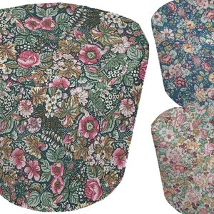 May include: Three fabric chair seat covers with floral patterns. The first cover is green with brown and pink flowers. The second cover is blue with pink and white flowers. The third cover is beige with pink and yellow flowers.