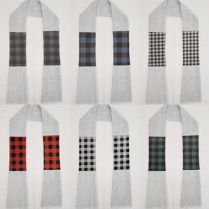 May include: Six different patterned scarves, each with a different color scheme. The scarves are all made of a soft, plush material and have a fringed edge. The patterns include black and white, red and black, blue and white, and green and black.