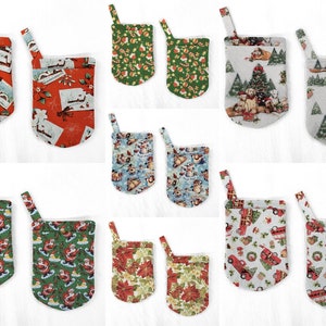 May include: Ten different Christmas-themed fabric pouches with a loop handle. The pouches feature various designs including Santa Claus, Christmas trees, and holiday greetings.