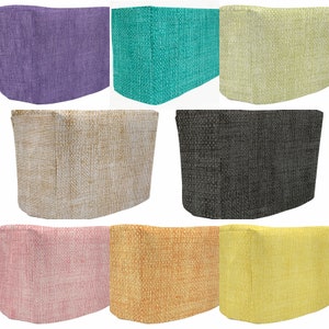 May include: Set of 10 fabric covers for a kitchen appliance, in various colors and patterns, including purple, teal, yellow, beige, black, pink, orange, and yellow.