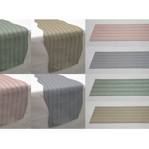 May include: Set of six table runners in various colors and patterns. The runners are made of a woven fabric with a subtle sheen. The colors include green, beige, pink, gray, and a darker green. The patterns are all stripes with a subtle geometric design.