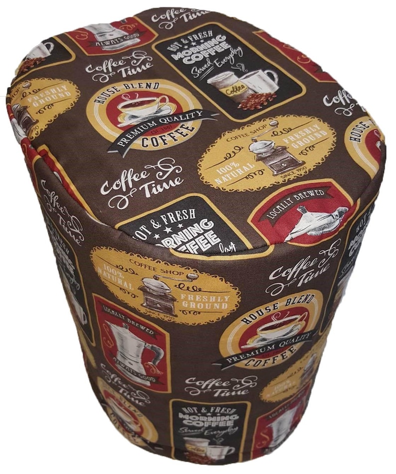 May include: Brown fabric with a repeating pattern of coffee-themed illustrations and text. The text includes "Coffee & Time", "Hot & Fresh Morning Coffee", "House Blend", "Premium Quality Coffee", "100% Natural", "Freshly Ground", "Locally Brewed", and "Coffee Shop".