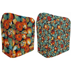 May include: Two kitchen appliance covers with a fall-themed print featuring orange, green, and brown gourds and leaves on a dark blue background.