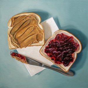 The artwork features a yet to be assembled peanut butter and jelly sandwich… the very moment just before you smoosh the two sides together.
