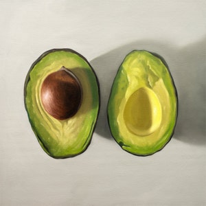 The artwork features a single avocado sliced in half and viewed from above on a light surface.