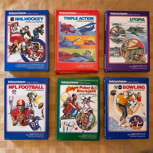 May include: Six Intellivision video game boxes arranged in two rows. The top row features NHL Hockey, Triple Action, and Utopia. The bottom row includes NFL Football, Las Vegas Poker & Blackjack, and Bowling. Each box displays colorful illustrations.