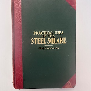 May include: A vintage book titled "Practical Uses of the Steel Square" by Fred T. Hodgson. The book has a dark green cover with gold lettering and a burgundy spine and corners. The book shows signs of wear.