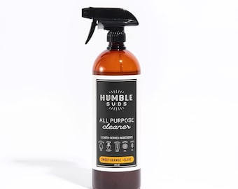 May include: A brown plastic bottle with a black spray nozzle. The bottle is labeled "Humble Suds All Purpose Cleaner" and "Sweet Orange - Clove".