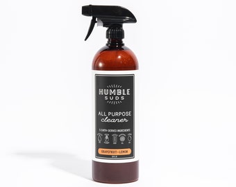 May include: A brown bottle with a black spray nozzle filled with all-purpose cleaner. The label reads "Humble Suds All Purpose Cleaner 5 Earth-Derived Ingredients Grapefruit + Lemon 32 fl oz".