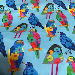 May include: A light blue fabric featuring a repeating pattern of stylized birds. The birds are depicted in various color combinations, including solid blue, green, yellow, and red, with some featuring floral-like shapes on their bodies.