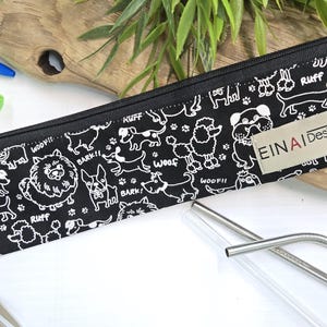 May include: Black zippered pouch with a white dog pattern and the text 'EIN AI Designs'. The pouch contains two silver metal straws.