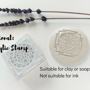 May include: An acrylic stamp with a geometric design, alongside a round stamp with the same pattern. The text reads "Optional: Acrylic Stamp" and "Suitable for clay or soap only, Not suitable for ink". Lavender sprigs are in the background.