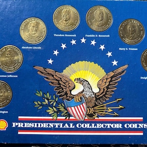 May include: A blue display case featuring Presidential Collector Coins. The coins depict U.S. presidents, including Abraham Lincoln, Theodore Roosevelt, and Franklin D. Roosevelt. The case has an eagle emblem and the text "PRESIDENTIAL COLLECTOR COINS".