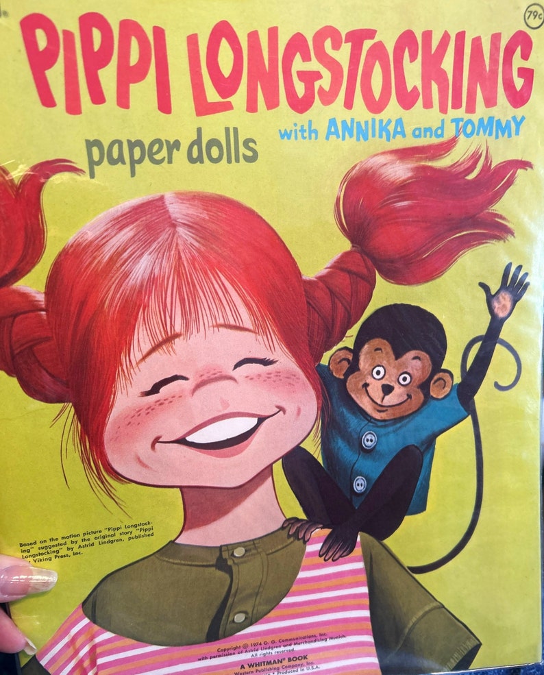 May include: A vintage paper doll book featuring Pippi Longstocking with Annika and Tommy. The cover features a colorful illustration of Pippi with her signature red hair and a monkey on her shoulder.
