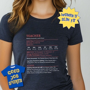 May include: A dark blue t-shirt with a white graphic design featuring a character sheet for a "Teacher" role-playing game character. The character sheet includes stats, skills, and abilities. The text "Women's Slim Fit" and "Good Job Shirts" are also visible on the shirt.