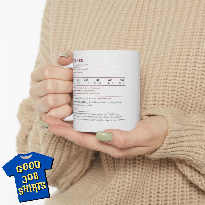 May include: White ceramic mug with a brown outline and text that reads "TEACHER" with a character sheet style stat block. The stats include: CON 19 (+4), INT 17 (+3), WIS 14 (+2), CHA 14 (+2).