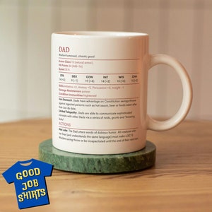 May include: White ceramic mug with a black and red design. The mug features a character called "Dad" with stats and abilities. The text reads "Medium humanoid, chaotic good" and "Armor Class 13 (natural armor)". The mug is sitting on a green coaster.