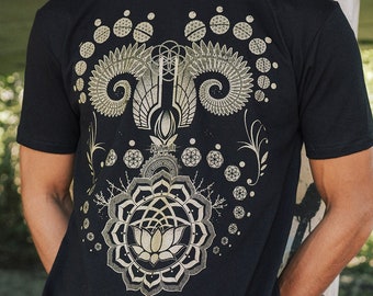 May include: A black t-shirt with a gold geometric design featuring a lotus flower, spirals, and the word "remarkable".