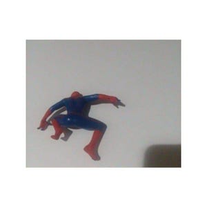 K&ouml;nnte beinhalten: Eine rote und blaue Plastik-Actionfigur von Spiderman in einer hockenden Pose mit ausgestreckten Armen.
