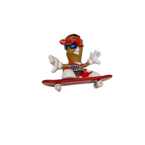 May include: A brown fingerboard figure with a red bandana, sunglasses, and a black and white striped shirt riding a red skateboard with white wheels.