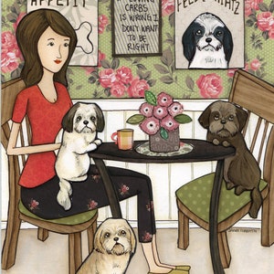 Può includere: Una donna è seduta a un tavolo con quattro cani Shih Tzu. La donna indossa una camicia rossa e pantaloni neri con un motivo floreale. I cani sono seduti su sedie e sulle gambe della donna. Ci sono due cartelli sul muro dietro la donna, uno che dice "Bone Appetit" e l'altro che dice "Feed the Shihtz".