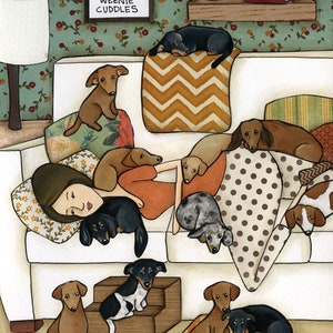May include: An illustration depicts a woman relaxing on a white sofa, surrounded by numerous Dachshund dogs. The dogs, in various colors, are lounging on pillows and the sofa. A sign reads "No Cuddles Like Weenie Cuddles."