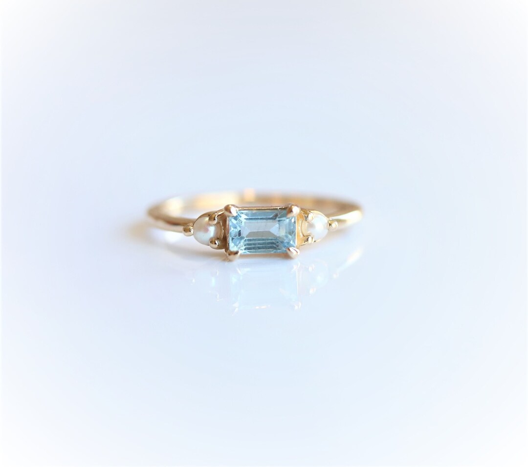 EVA Side Stone Emerald Cut Aquamarine and Pearl East West Ring