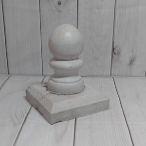 May include: White concrete fence post finial with a round top and a square base.