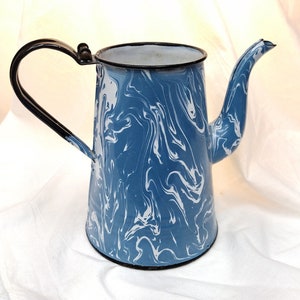 May include: Blue and white enamelware coffee pot with a black handle and spout.