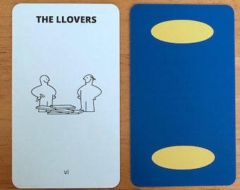 May include: Two rectangular playing cards. The left card is white with the text THE LLOVERS, a black line drawing of two figures with wood planks, and the roman numeral vi. The right card is solid blue with two yellow ovals.