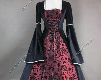 May include: A black velvet and red brocade long-sleeved gown with a lace-trimmed neckline and a fitted bodice. The gown has a full skirt and a long train.