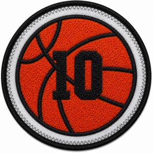 May include: A circular embroidered patch featuring a textured orange basketball design with black lines. The number 10 is centered in black, bold, block lettering. The patch is bordered by a white ring and finished with a black stitched edge.