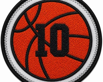 May include: A circular embroidered patch featuring a textured orange basketball design with black lines. The number 10 is centered in black, bold, block lettering. The patch is bordered by a white ring and finished with a black stitched edge.