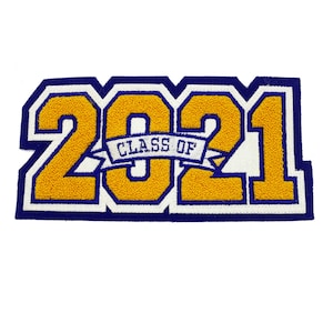 May include: A gold and white felt patch with the number 2021 in large, bold font. The numbers are outlined in blue and a blue banner with the text "CLASS OF" is between the 0 and the 21.
