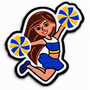 May include: An embroidered patch featuring a cheerleader with long brown hair, wearing a white and blue top with a blue skirt, jumping while holding two pom-poms with yellow and blue segments, all outlined with a thick black border.