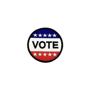 May include: A red, white, and blue circular button with the word "VOTE" in black letters. The button has a blue outer ring with white stars and a red inner ring with white stars.