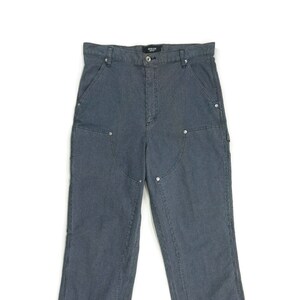 May include: A pair of dark gray carpenter jeans with multiple pockets and reinforced seams.