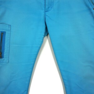 May include: A pair of blue denim trousers with a zipped cargo pocket on the left leg.