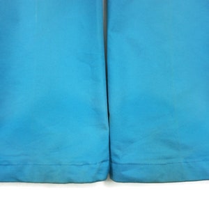 May include: A pair of blue trousers with a straight leg and a hemmed bottom.