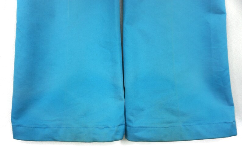 May include: A pair of blue trousers with a straight leg and a hemmed bottom.