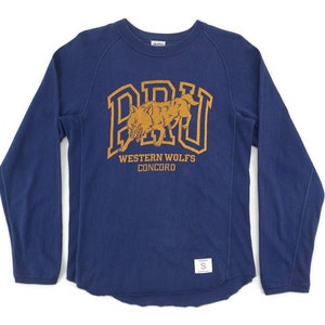 May include: A navy blue long-sleeved sweatshirt with a gold graphic of a wolf and the text "BRU WESTERN WOLFS CONCORD".