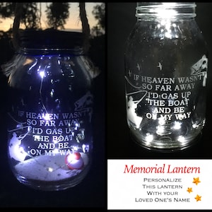 May include: A glass jar lantern with a white silhouette of a fisherman and the text "If heaven wasn't so far away I'd gas up the boat and be on my way". The jar is lit with white LED lights and has a red fishing bobber at the bottom. The text "Memorial Lantern" is below the jar with stars and the text "Personalise this lantern with your loved one's name".