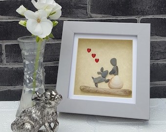 Handmade Pebble Art in Grey Frame, Showing a Lady or Girl Sitting with her Pet Dog