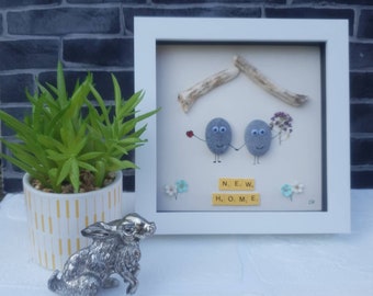 Handmade Pebble Art in White Frame, Showing a Couple in their New Home