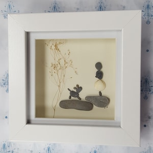 Handmade Pebble Art in Wooden White Frame, Showing a Lady or girl with Pet Dog