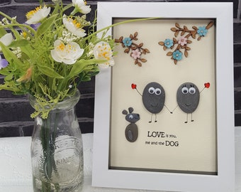 Pebble Art in White Frame, Showing a Loving couple standing by a blossom tree with their dog