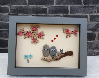 Handmade Pebble Art in Grey Frame, showing couple with pet cat on driftwood log