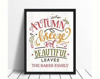 May include: A framed print with a white background and black frame. The print features a handwritten quote that reads "Autumn breeze and beautiful leaves. The Baker Family".